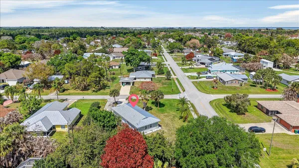an aerial view of residential houses with outdoor space and swimming pool