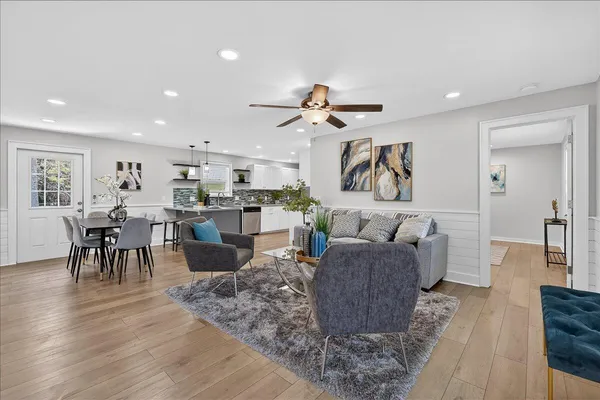 a living room with furniture kitchen view and a dining table