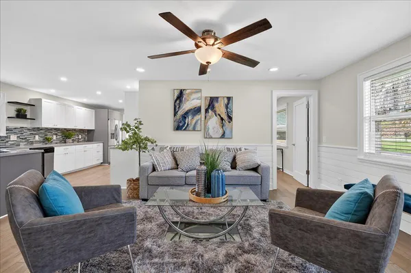a living room with furniture and kitchen view