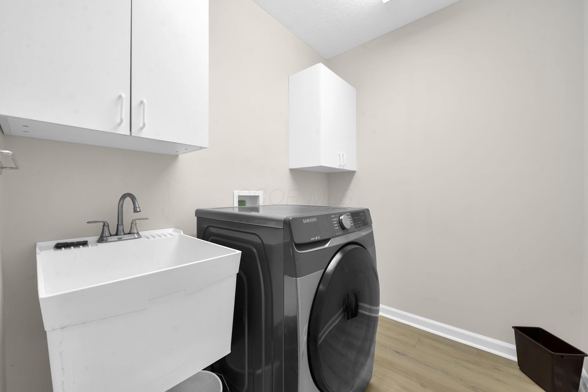 6218 Country Side Road Plain City, OH 43064 - Photo 25 of 28 Laundry room with sink & storage