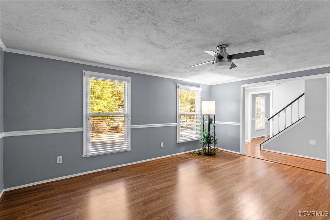 1200 Oldbury Road Midlothian, VA 23113 - Photo 12 of 42 a view of a livingroom with wooden floor and a ceiling fan