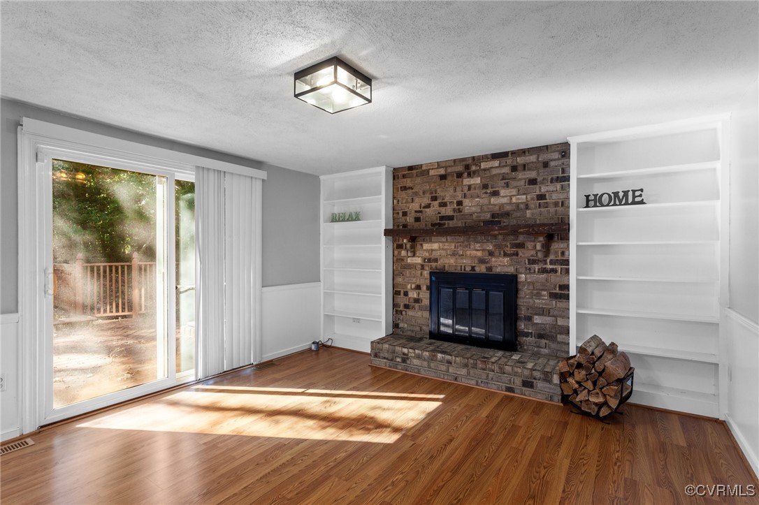 1200 Oldbury Road Midlothian, VA 23113 - Photo 2 of 42 a living room with a fireplace and wooden floor