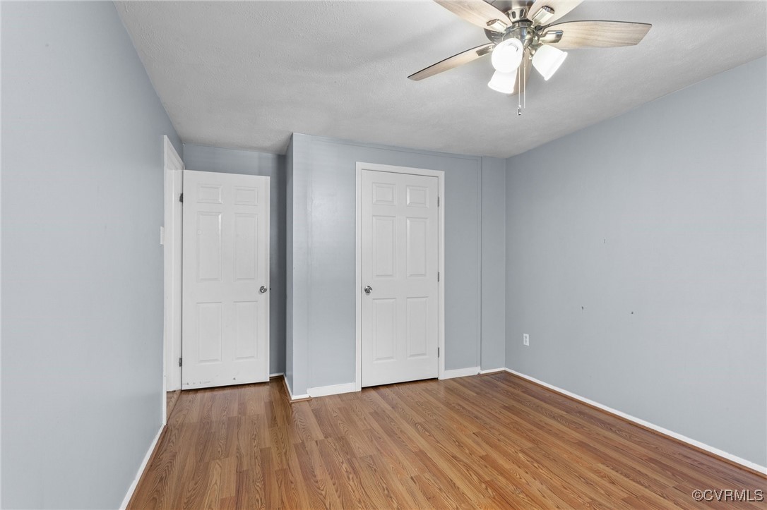 1200 Oldbury Road Midlothian, VA 23113 - Photo 32 of 42 a view of an empty room with wooden floor and a chandelier fan