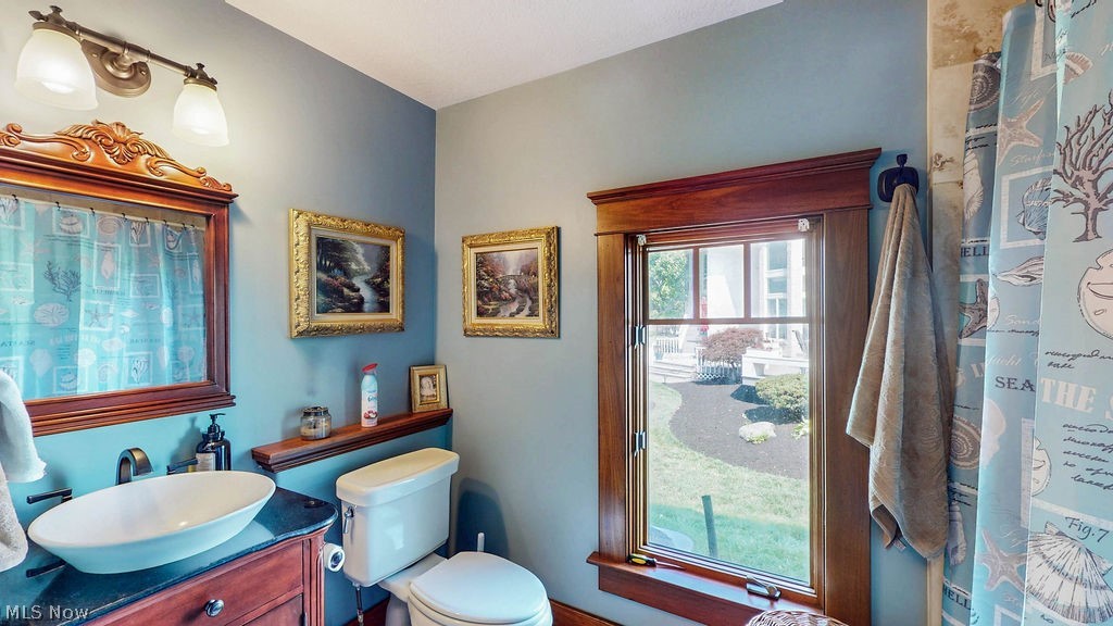 1431 Cedar Point Road Sandusky, OH 44870 - Photo 22 of 50 Bathroom with vanity and a shower with shower curtain