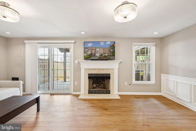 a living room with furniture window and fireplace