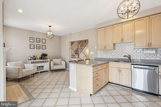 a kitchen with a stove a sink and cabinets