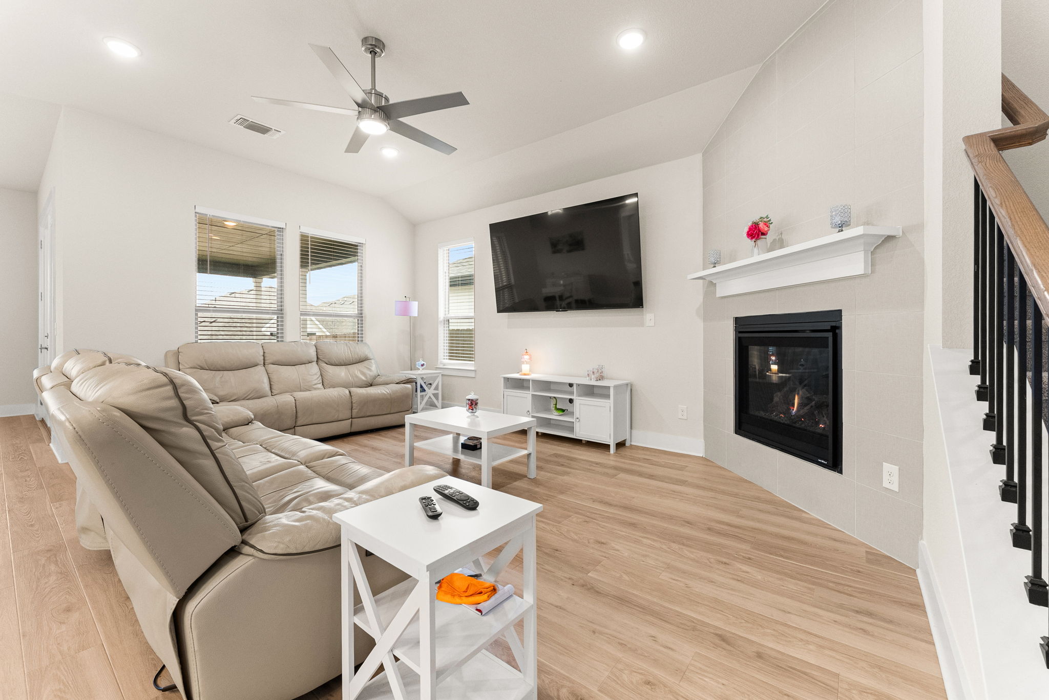 9508 Hamadryas Drive Austin, TX 78744 - Photo 13 of 40 The spacious family room features a corner gas fireplace with mantle, ceiling fan with light, recessed lighting, and two-inch blinds.