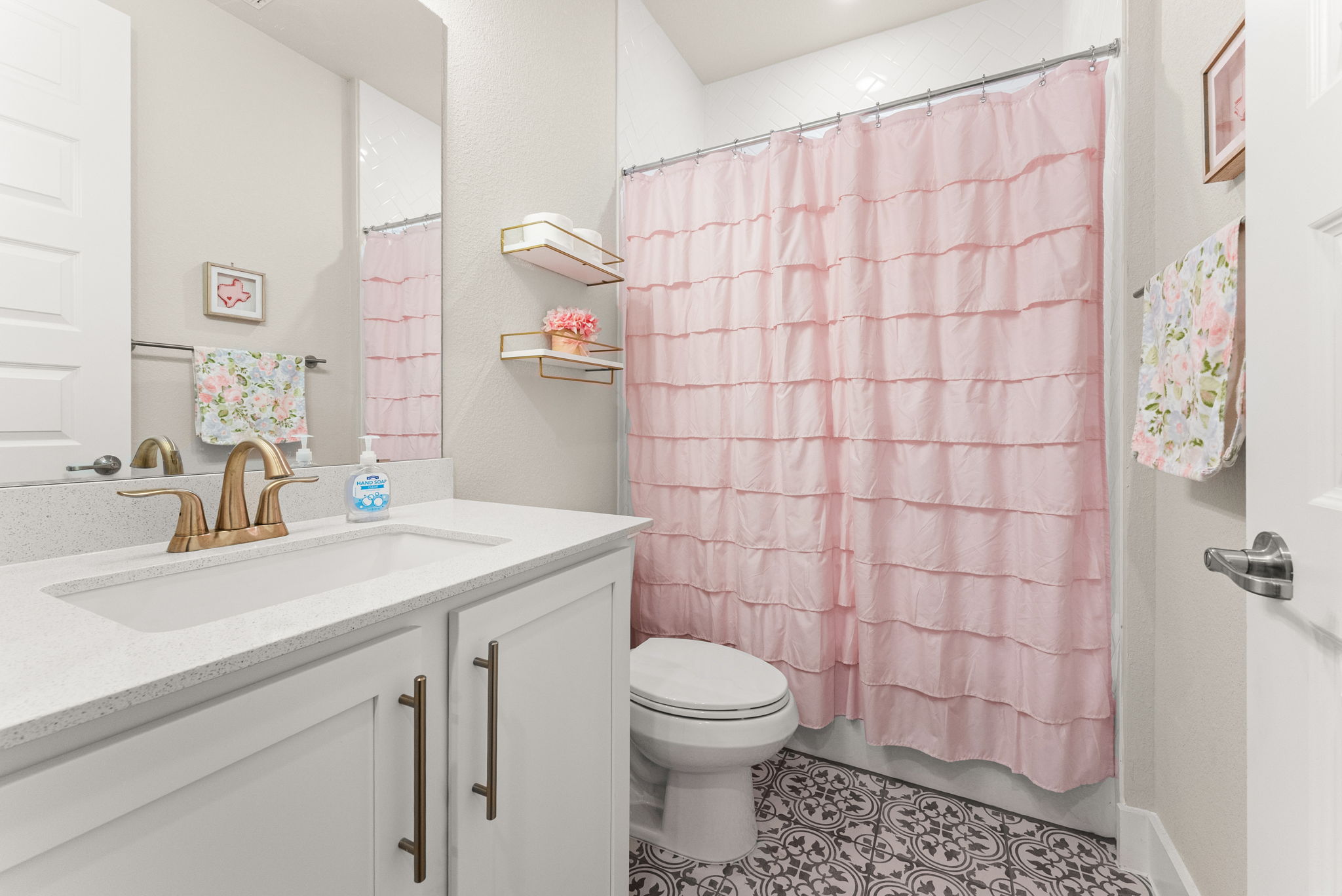 9508 Hamadryas Drive Austin, TX 78744 - Photo 22 of 40 The second bathroom is on the first floor, right next to Bedroom 2. It is a full bath with a decorative tile floor.