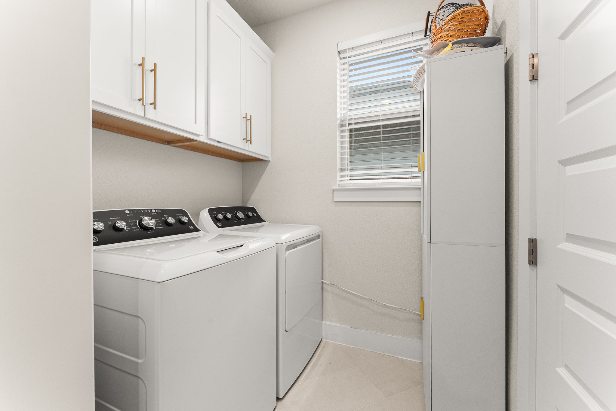 9508 Hamadryas Drive Austin, TX 78744 - Photo 24 of 40 The laundry room has built-in cabinets, a window with two-inch blinds, and direct access to the master closet.