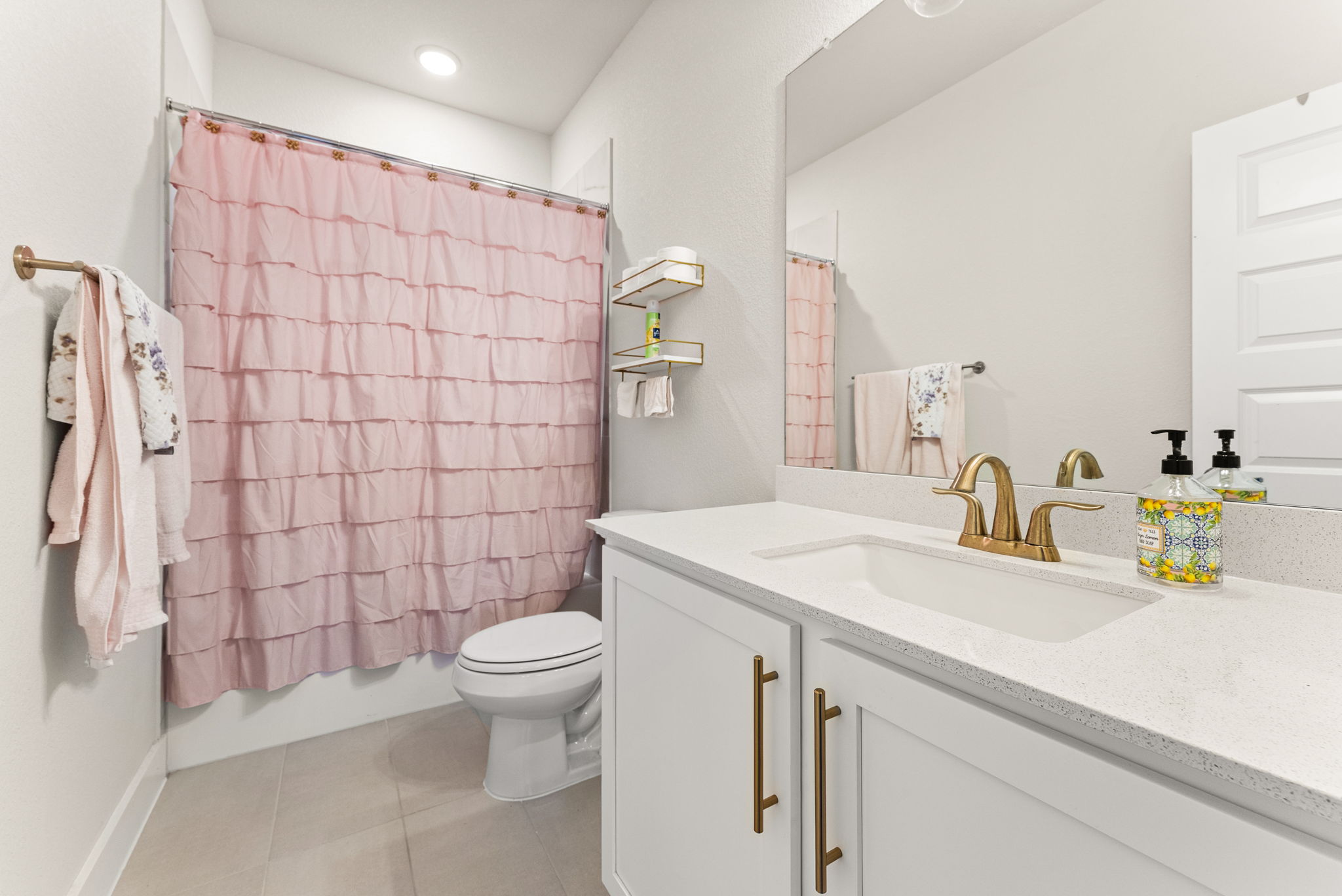 9508 Hamadryas Drive Austin, TX 78744 - Photo 34 of 40 The third full bath has tile flooring and a standard-sized tub & shower with tile surround.