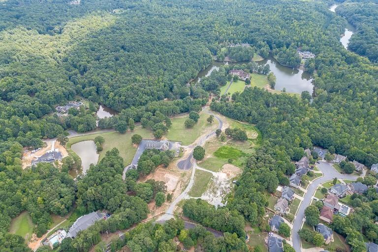 5775 Kennedy Road Suwanee, GA 30024 - Photo 22 of 23 an aerial view of residential house with outdoor space and lake view