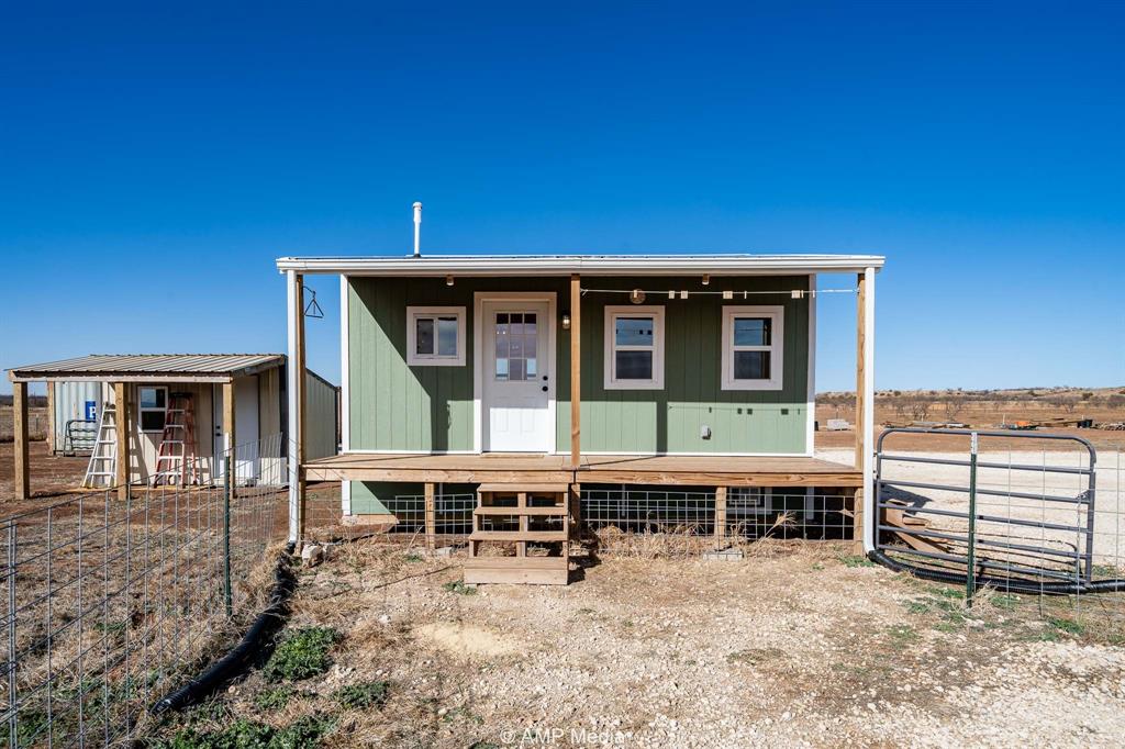 a view of a house with wooden deck and a backyard