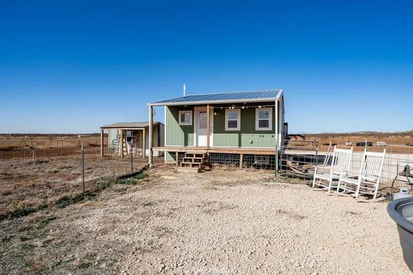 a view of a house with wooden deck and a big yard
