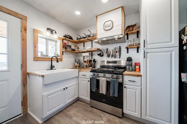 a kitchen with stainless steel appliances granite countertop a stove and a sink