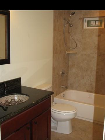 300 South Holokai Road Haiku, HI 96708 - Photo 11 of 16 a bathroom with a granite countertop sink toilet and shower