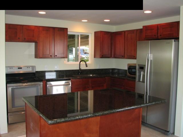 300 South Holokai Road Haiku, HI 96708 - Photo 8 of 16 a kitchen with granite countertop a refrigerator and a sink