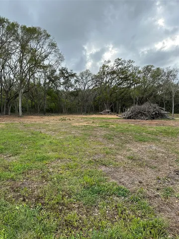 a view of outdoor space with green field and trees