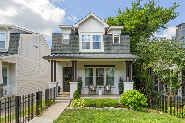 a living room with couches a coffee table and chairs with wooden floor