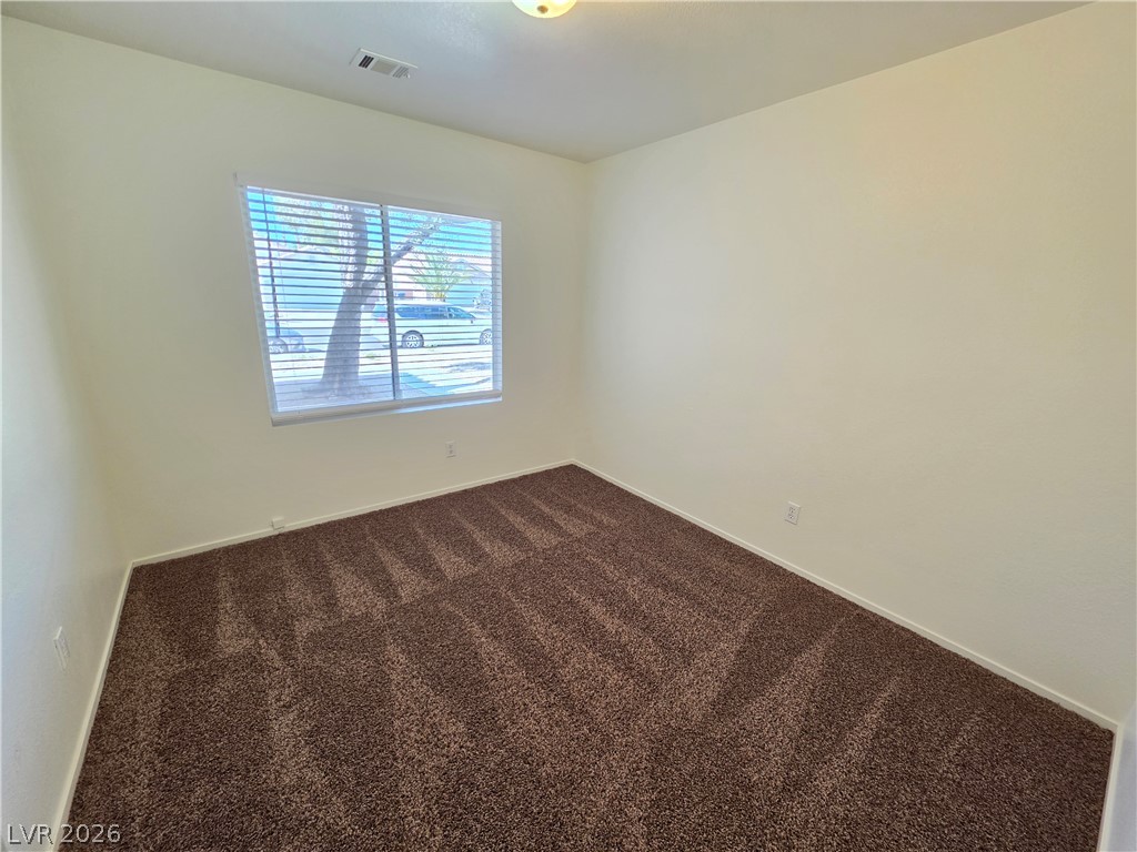 1154 Point Success Avenue Henderson, NV 89014 - Photo 13 of 26 An inviting room features plush carpeting, creating a comfortable and serene atmosphere.