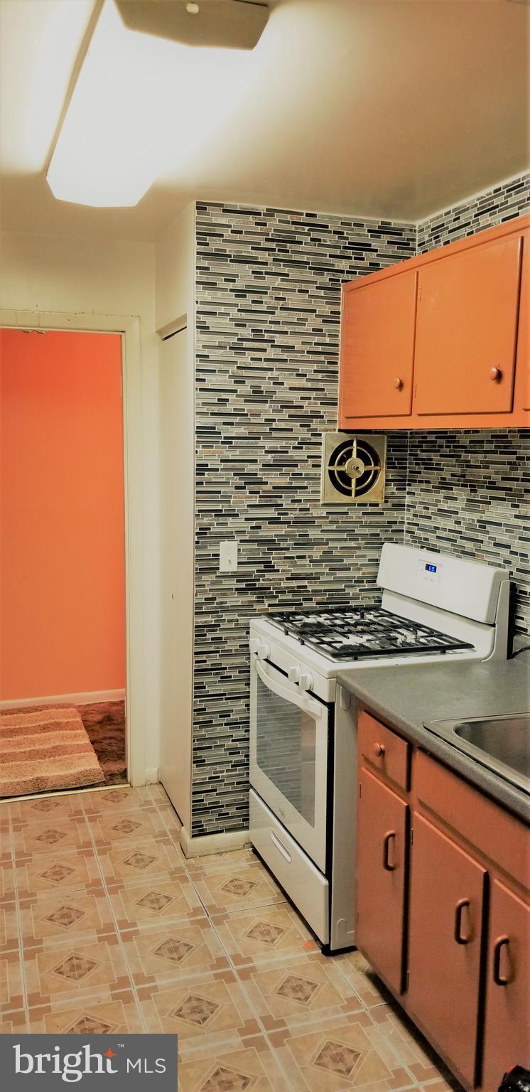 3863 St Barnabas Road, Unit T Suitland, MD 20746 - Photo 6 of 6 a kitchen with stainless steel appliances granite countertop a stove a sink and a microwave