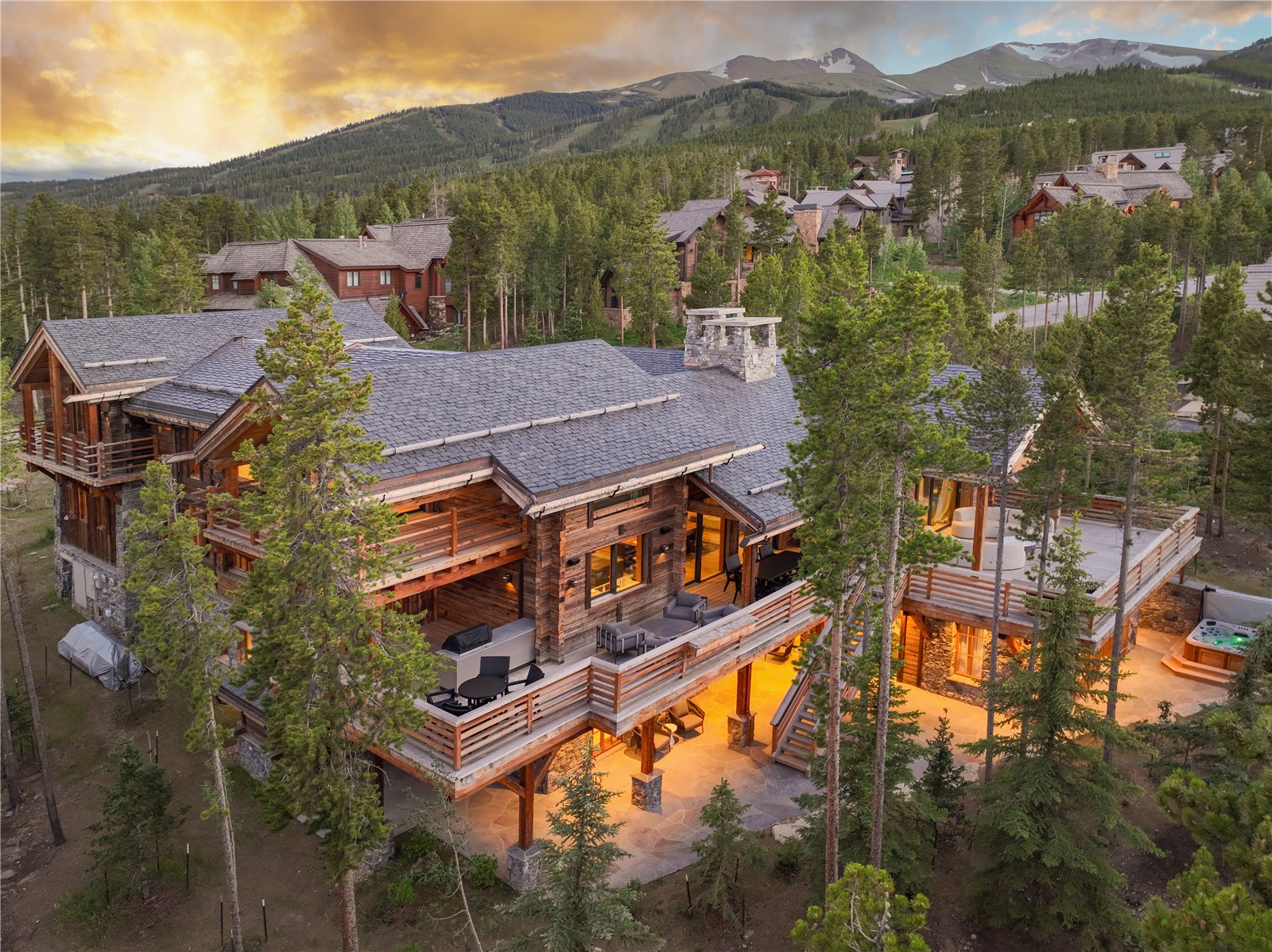 an aerial view of residential houses with outdoor space and trees
