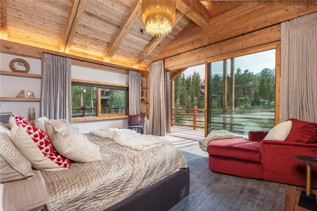 a bedroom with furniture and a large window