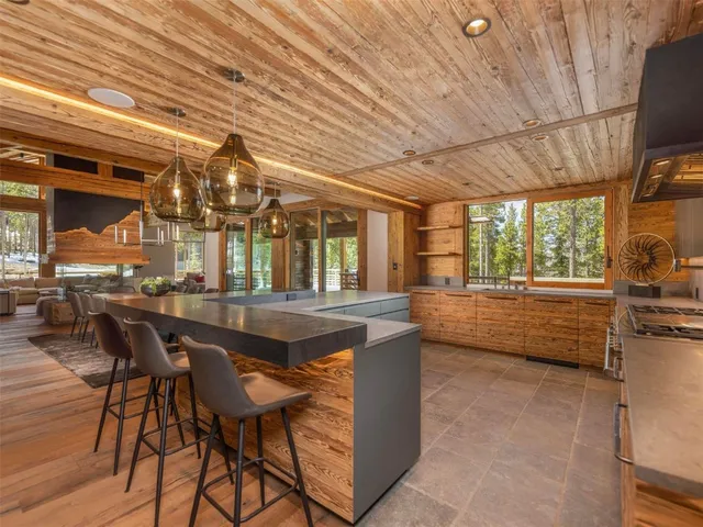 a dining room with furniture and a floor to ceiling window