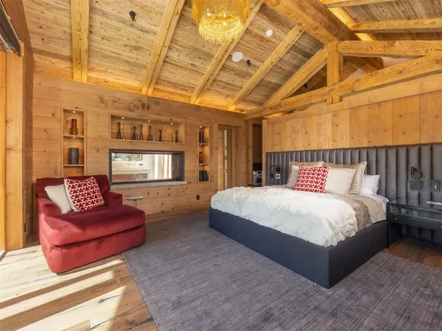 a bedroom with bed and wooden floor