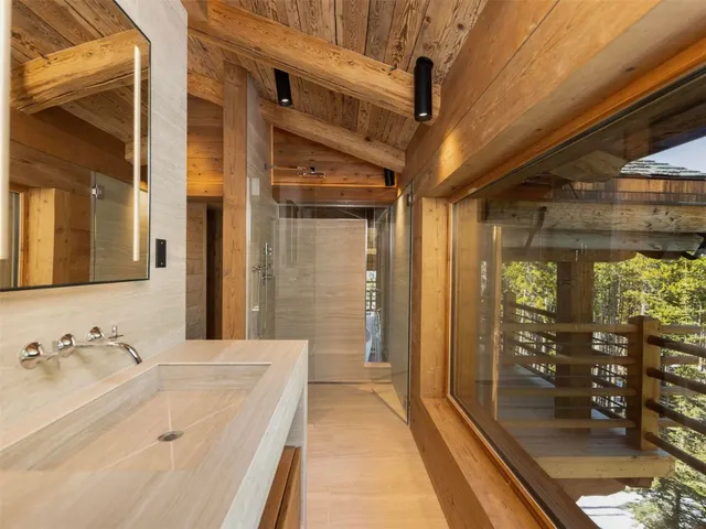 a bathroom with a double vanity sink and a mirror