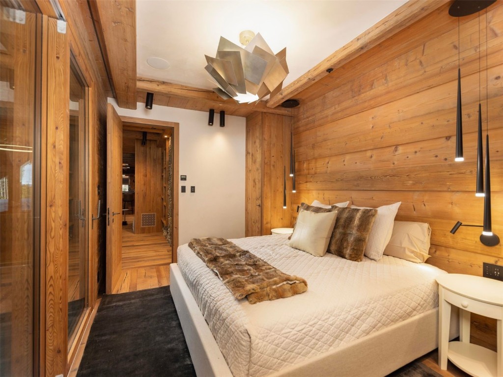 256 Timbertrail Road Breckenridge, CO 80424 - Photo 24 of 31 a bedroom with a bed and a chandelier