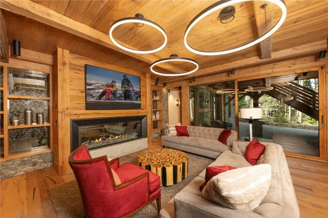 a living room with furniture a fireplace and a large window