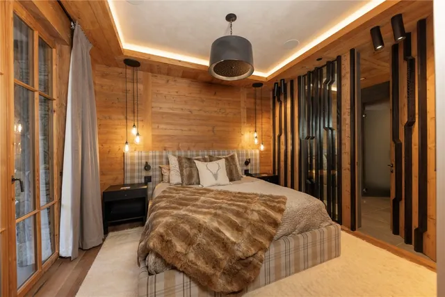 a bedroom with a bed and a chandelier