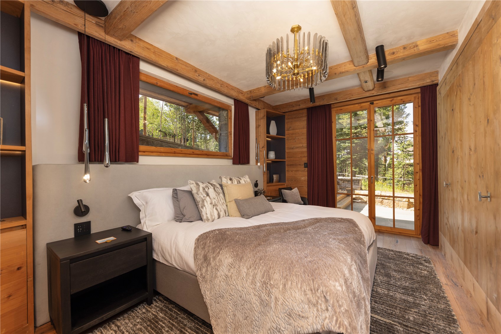 256 Timbertrail Road Breckenridge, CO 80424 - Photo 10 of 31 a bedroom with a large bed and a chandelier