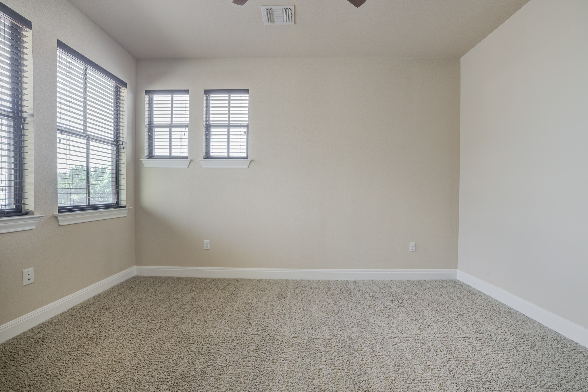 4524 Berkman Drive Austin, TX 78723 - Photo 32 of 38 Carpeted room with multiple windows featuring horizontal blinds
