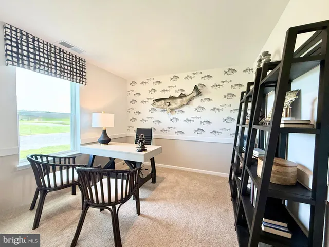 a view of a dining room with furniture and a window