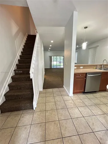 a view of kitchen with sink and natural light