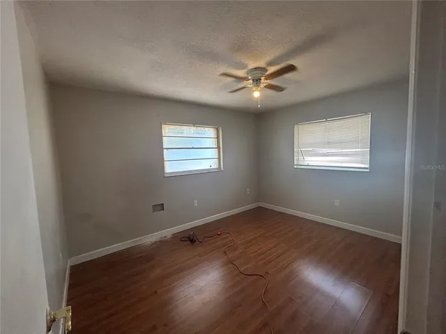 a bedroom with a table and window