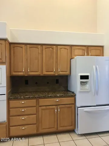a kitchen with a refrigerator stove and cabinets