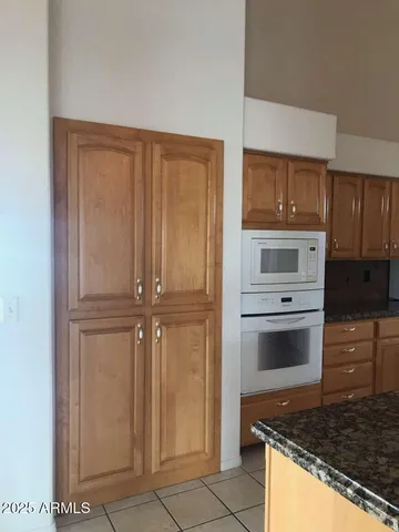 a view of a livingroom with a fireplace wooden floor and cabinet