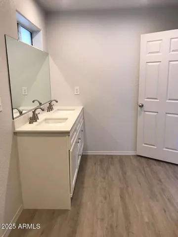 an empty walk in closet with wooden floor
