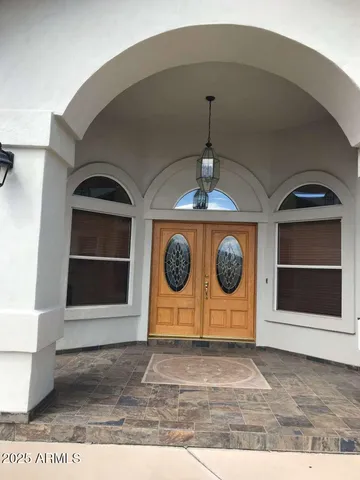 a view of a hallway with washer and white walls