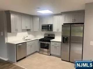 a kitchen with a refrigerator stove and microwave