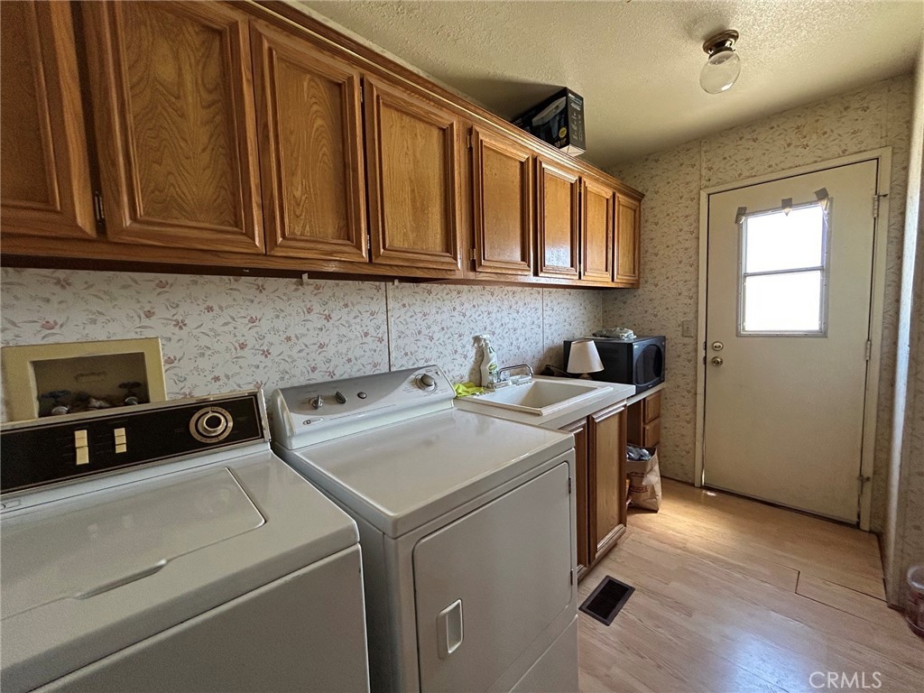 27250 Murrieta Road, Unit 347 Menifee, CA 92586 - Photo 29 of 39 a utility room with stainless steel appliances granite countertop a washer and dryer
