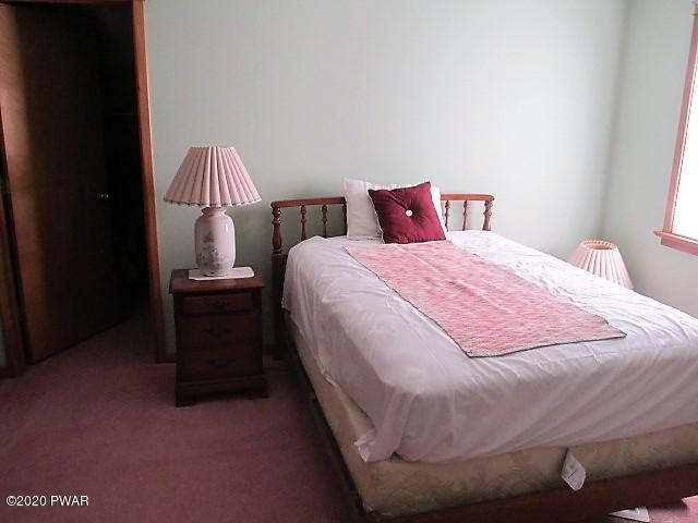 996 Cortez Road Lake Ariel, PA 18436 - Photo 35 of 55 a bed sitting in a bedroom next to a lamp