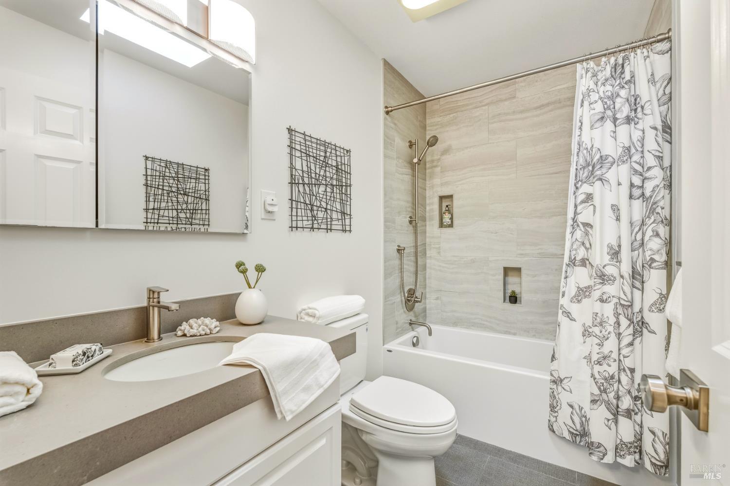 829 Las Pavadas Avenue San Rafael, CA 94903 - Photo 42 of 55 Updated bath features a quartz-topped vanity, tile surround, Hansgrohe fixtures and a skylight...