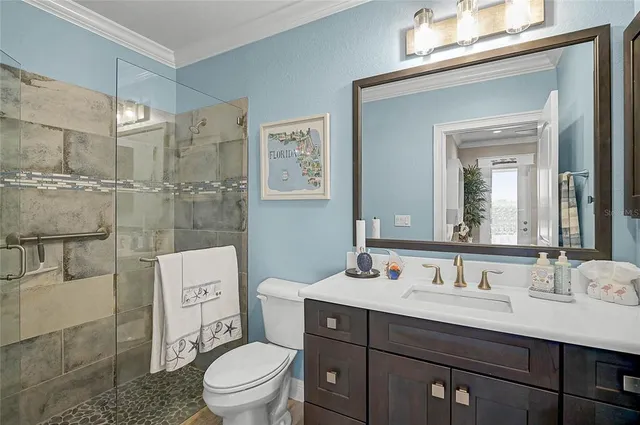 a living room with furniture a ceiling fan and a flat screen tv