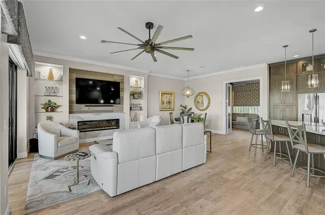 a living room with furniture a flat screen tv and a large window