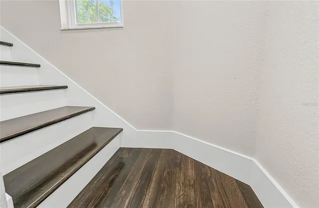 a en suite bathroom with a granite countertop sink and a mirror