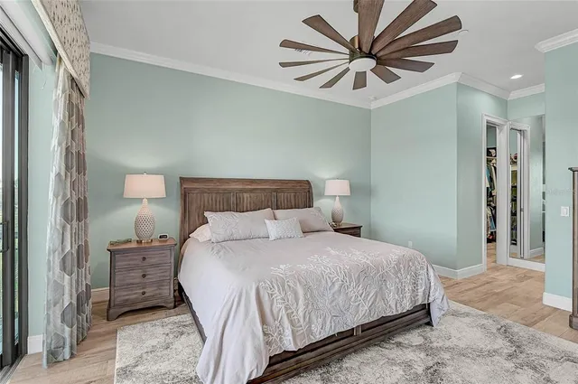a porch with a dining table and chairs with potted plants