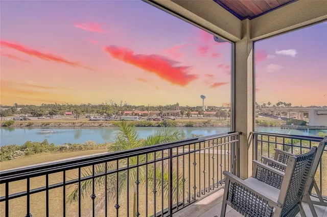 an aerial view of a house with a yard and lake view